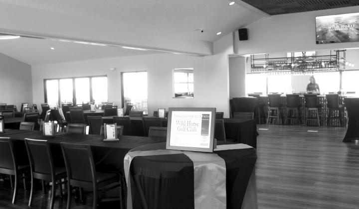 ABOVE: The new covered patio at Wild Horse Golf Club has become the most popular spot in the clubhouse, and with a view like this of the valley it is easy to see why. LEFT: The newly renovated dining room and bar area at Wild Horse Golf Club provides seating for up to 120 people, with dining available for both club members and non-members all day every day. (Leader photos by Ellen Mortensen)