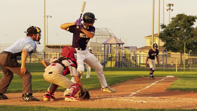 Andrew Salomon waits on the ball from the McCook pitcher as Evan Geiser eagerly anticipates bolting from third base to score. (Photos courtesy Niki Salomon)