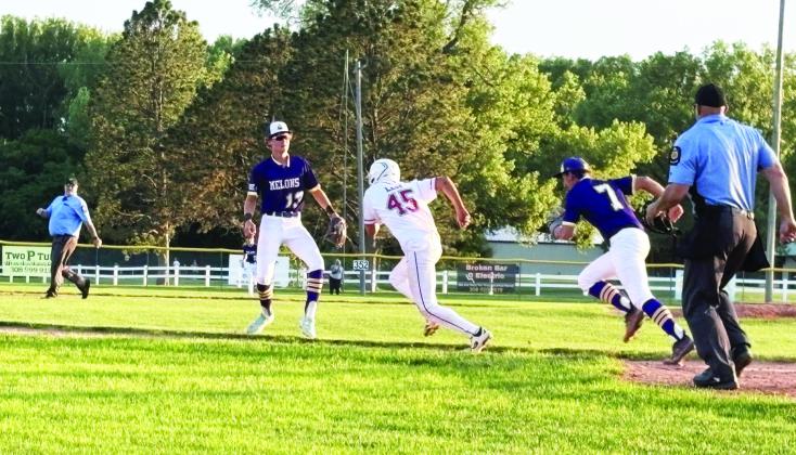 Third baseman William McVay and pitcher Evan Geiser (who tagged the runner) caught an Alma player in a pickle in last Friday’s game at Alma. (Photo courtesy Kim Johnson)