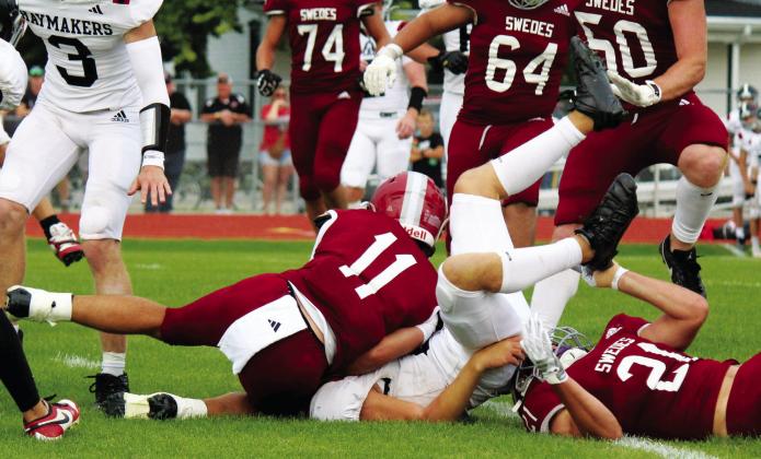 Tristan Koch (#21) landed underneath the Cozad ball carrier as he made the stop, assisted by Braden Ehlers (#11).