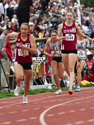 Adalyn Carlson hands the baton off to Ellaray Koch during the girls’ 4x800 relay in Omaha. The team finished 12th.