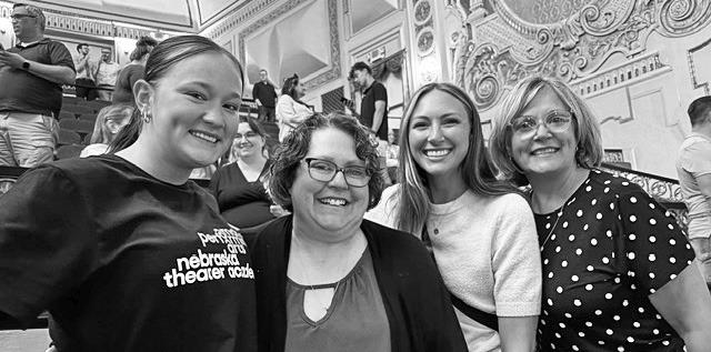 Kaylee Olsen, far left, shares a moment at Omaha’s Orpheum Theatre with her musical theatre coaches Erin Feather, Makayla Franzen, and Lori Long.