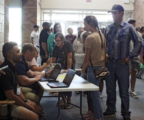An important stop for students during the open house was the station to get signed up for power school, an information system that allows students and parents to track and manage grades, assignments, and other academic data.