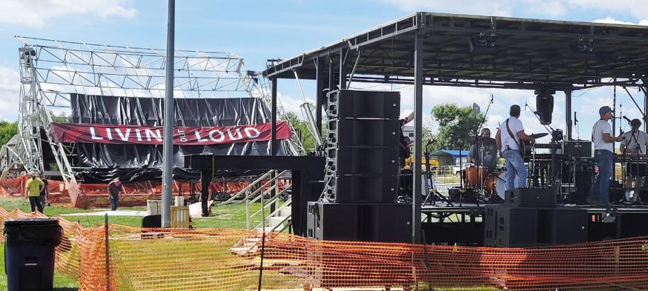 The small stage typically used as the sound booth for Livin’ Out Loud was transformed into the main stage Saturday, while the collapsed large stage remained visible in the background. (Leader photos by Ellen Mortensen)