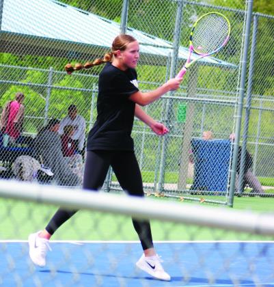 Lindly Anderson returns a serve during doubles play in Kearney on April 27.