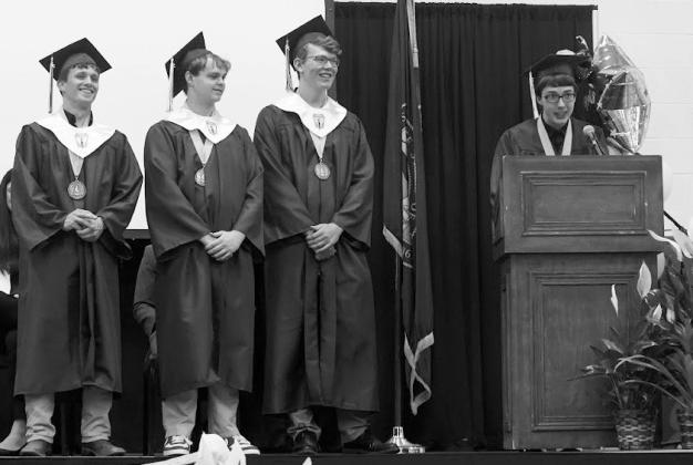 From left: GHS seniors Carson Reiman, Jack Aden, Mavrix Butterfield, and Lathan Buesing gave opening remarks for the 2026 Gothenburg High School graduation on Sunday.