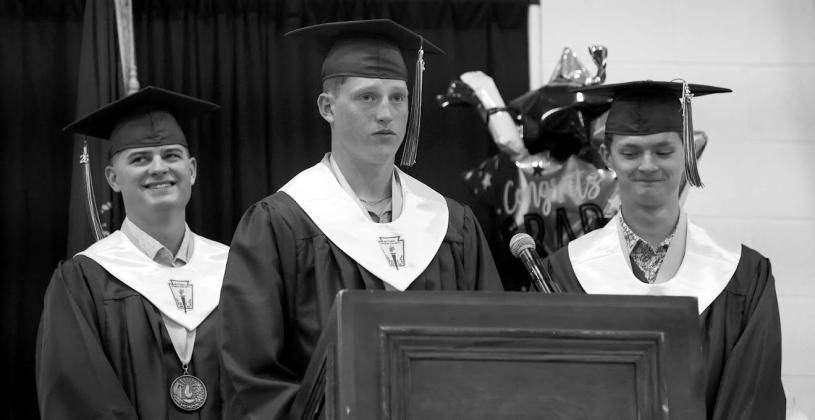 From left: Boone Tederman, Axel Jorgenson, and Logan Feather gave the final closing remarks before the Class of 2026 exited the gym one final time. (Leader photos by Charity Wyatt)