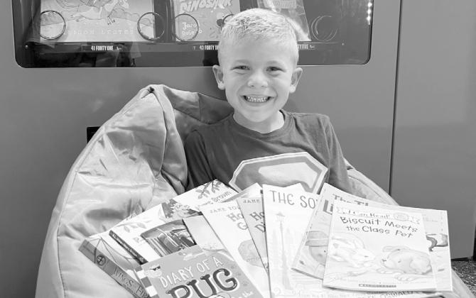 Dudley Elementary gives a huge shoutout to Baylor Haake for completing the 1,000 Books Before The End of Kindergarten Challenge. With help from his mom, dad, and big sister Harper, Baylor read 1,000 books - and especially loved looking at all the pictures along the way. To celebrate, he picked out 10 new books from Mrs. Floyd's office, including one from the TeamMates Vending Machine. (Photo courtesy Dudley Elementary)