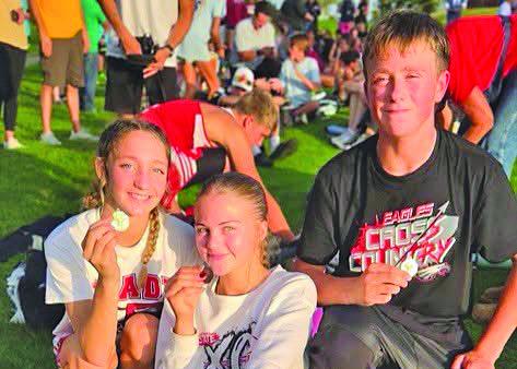 Brady cross country medalists Paisley Connelly, Zoe Johnson and Gus Barnes show off their medals following the Arapahoe Invite on Sept. 17. Connelly placed first, while Johnson and Barnes each finished third. (Photo courtesy of Brady Public Schools)