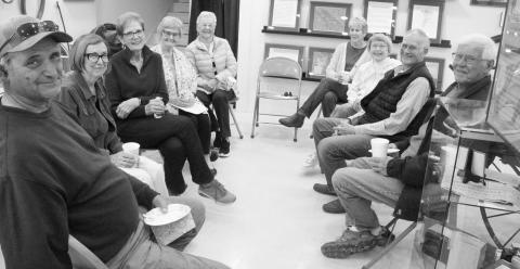 ABOVE: The Gothenburg Historical Museum is operated completely by local volunteers. Those on hand for the open house on April 27 were, clockwise from left: Mark Alberts, Liz Frerichs, Anne Anderson, Karen Sawyer, Marcy Aden, Joyce Hudson, Jan Gill, Dick Larson, and Roger Heidebrink. BELOW: Jan Gill checks out one of the displays at the Gothenburg Historical Museum during the open house on April 27. (Leader photos by Ellen Mortensen)