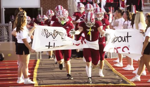 Senior Jaxon Earll leads the Swedes onto the field for last week’s game against Mitchell. Gothenburg improved its record to 3-0 with a 45-29 win. (Leader photos by Charity Wyatt)