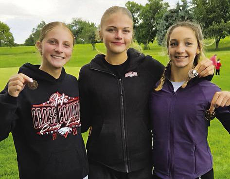 Brady cross country medalists Violet Gentry, Zoe Johnson and Paisley Connelly pose following the Broken Bow Invite on Sept. 12. Johnson placed sixth, Gentry finished 15th and Connelly placed eighth in the junior high race. (Photo courtesy Brady Public Schools)