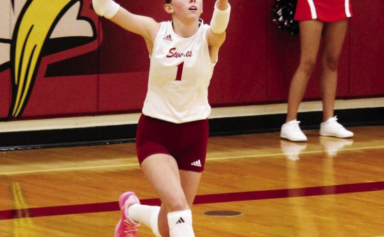 Lauren Mroczek takes her turn at the service line for the Lady Swedes against Cozad last week.