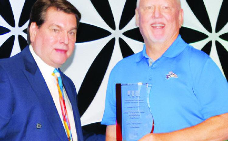 Dr. Mike Teahon accepts the NCSA Distinguished Service Award from NCSA Executive Director Dr. Mike Dulaney at Administrators' Days last week in Kearney. (Courtesy photo)
