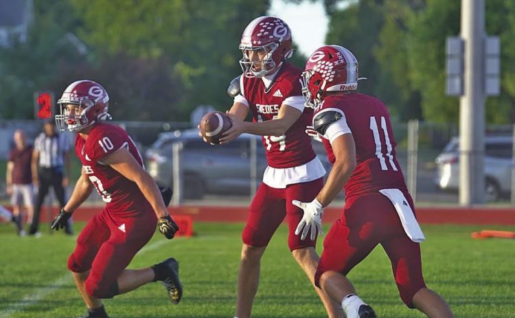 Callen Johnson (#10) prepares to set up a block as QB Dillon Floyd (#14) hands the ball off to Braden Ehlers (#11) earlier this season. Ehlers and Floyd teamed up for 3 rushing touchdowns against Ogallala last week, while Johnson was credited with 5 tackles on the night.