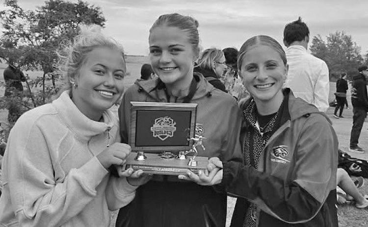Brady runners Brooke Lydic, Zoe Johnson, and Violet Gentry hold the runner-up trophy following the Maywood- Hayes Center Meet on Sept. 23. Johnson placed second and Gentry finished fifth as the Brady girls earned the runner-up team title. (Photo courtesy of Brady Public Schools)