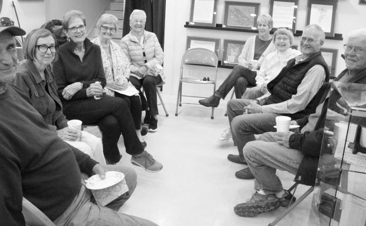 ABOVE: The Gothenburg Historical Museum is operated completely by local volunteers. Those on hand for the open house on April 27 were, clockwise from left: Mark Alberts, Liz Frerichs, Anne Anderson, Karen Sawyer, Marcy Aden, Joyce Hudson, Jan Gill, Dick Larson, and Roger Heidebrink. BELOW: Jan Gill checks out one of the displays at the Gothenburg Historical Museum during the open house on April 27. (Leader photos by Ellen Mortensen)