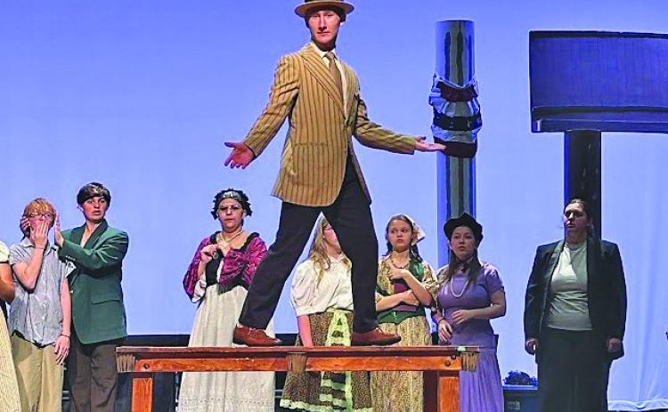 Carter Kincheloe (on the table) is the only senior in this year’s GHS musical and will bring the character of Harold Hill to life in “The Music Man” this weekend. Performances are Friday and Saturday at 7 p.m., and Sunday at 2 p.m. in the PAC at the high school. (Photo courtesy Erin Beavers)