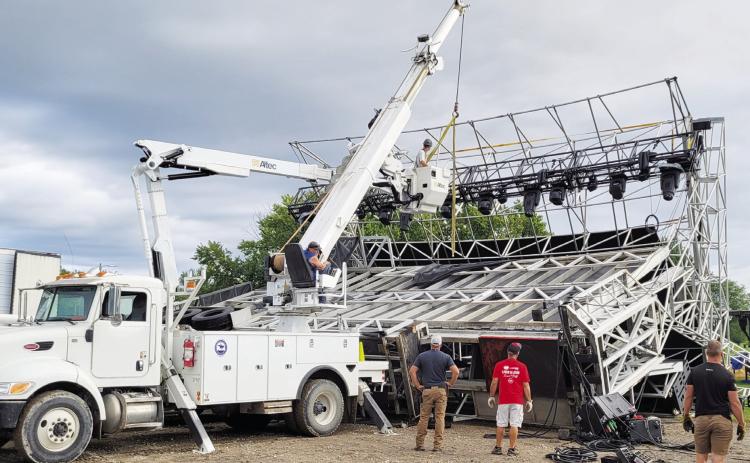 A crew from the City of Gothenburg was on scene early Saturday morning at Lake Helen after receiving word that the stage for Livin’ Out Loud had been blown down in the wee morning hours. The crew used a bucket truck to remove the lights from above the stage and helped stabilize the structure before returning on Sunday afternoon to assist with dismantling the wreckage. (Leader photo by Ellen Mortensen)