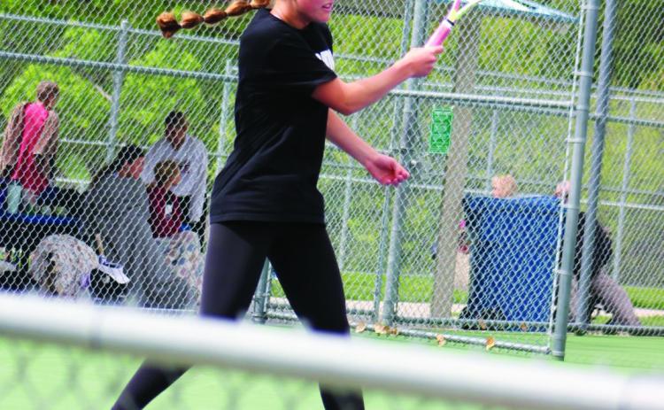 Lindly Anderson returns a serve during doubles play in Kearney on April 27.