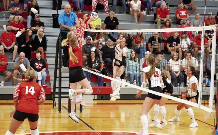 Kenlee Fattig and Ava Foster team up at the net to contest an opposing attack. (Photo courtesy Brady Public School)