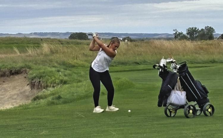 Adyson Stevens concentrates on her swing last Tuesday in a tournament at Wild Horse Golf Club.